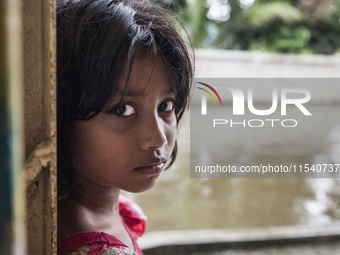 A small child looks innocent inside a flood shelter in Sonapur Union of Sonaimuri Upazila, Noakhali District, Chittagong Division, Banglades...