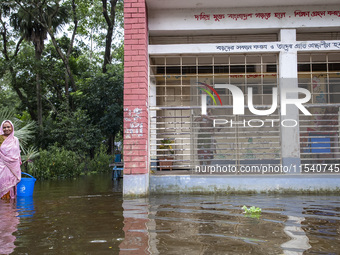 Some children stand on the balcony after taking shelter in a school due to floods in Sonapur Union of Sonaimuri Upazila of Noakhali District...