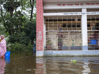 Some children stand on the balcony after taking shelter in a school due to floods in Sonapur Union of Sonaimuri Upazila of Noakhali District...