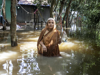 An elderly woman stands in waist-deep flood water in a village of Sonapur Union in Sonaimuri Upazila of Noakhali District of Chittagong Divi...