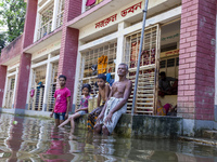 A few elderly people and children sit in front of a shelter after the floods in Sonapur Union of Sonaimuri Upazila of Noakhali District of C...