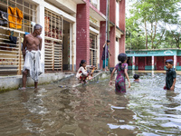 A few children bathe in flood water in front of a flood shelter in Sonapur Union of Sonaimuri Upazila of Noakhali District of Chittagong Div...