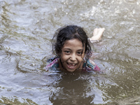 A child bathes in flood water in front of a flood shelter in Sonapur Union of Sonaimuri Upazila of Noakhali District of Chittagong Division...