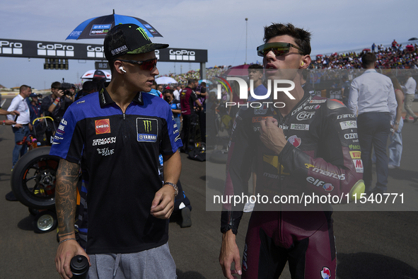 (L) Fabio Quartararo (20) of France and Monster Energy Yamaha Moto GP and (R) Tony Arbolino (14) of Italy and Elf Marc Vds Racing Team Kalex...