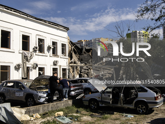 A view of the heavily damaged cars and partially collapsed building after the Russian missile attacks in Kyiv, Ukraine, on September 2, 2024...