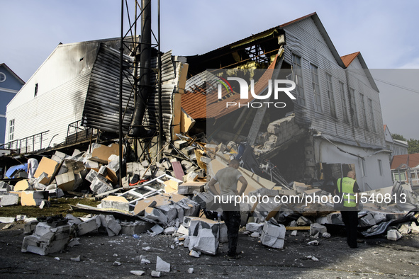 Experts work near the sports complex of a university on a heavily damaged and partially collapsed building after the Russian missile attacks...