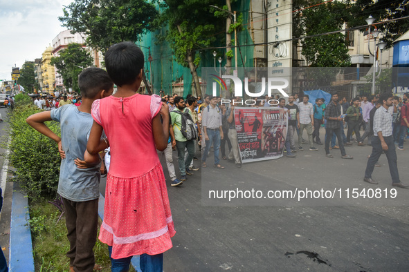 Children observe a protest rally by doctors regarding the rape and murder of a second-year PGT doctor in Kolkata, India, on September 2, 202...