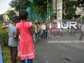 Children observe a protest rally by doctors regarding the rape and murder of a second-year PGT doctor in Kolkata, India, on September 2, 202...