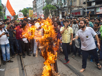 Junior doctors burn an effigy of the Kolkata police commissioner during a protest rally against the rape and murder of a doctor in Kolkata,...