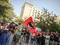 A young man holds an Anti Fascist Action flag during a demonstration staged by human rights activists, women's rights organizations, and civ...