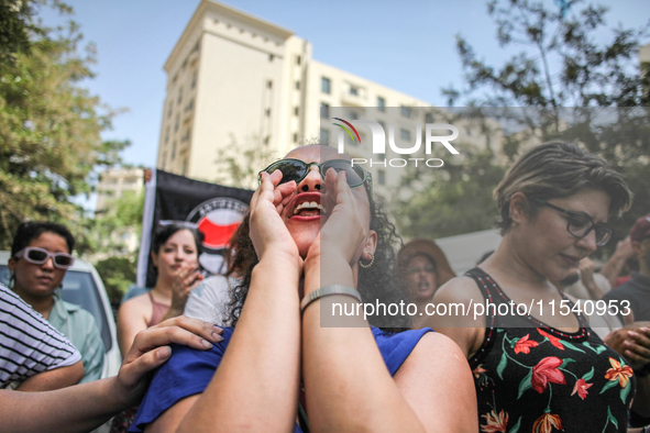 A female demonstrator shouts slogans as she attends a demonstration staged by human rights activists, women's rights organizations, and civi...