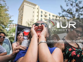 A female demonstrator shouts slogans as she attends a demonstration staged by human rights activists, women's rights organizations, and civi...