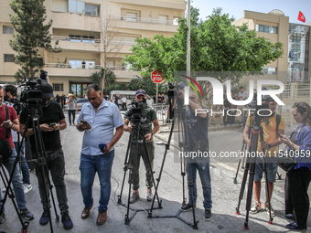 Photographers and journalists from the press and media cover a demonstration staged by human rights activists, women's rights organizations,...