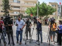 Photographers and journalists from the press and media cover a demonstration staged by human rights activists, women's rights organizations,...