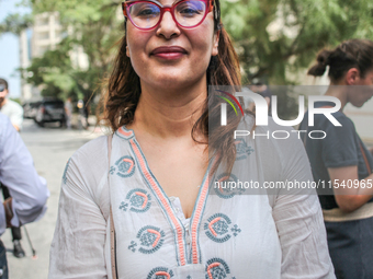 Chaima Issa, human rights activist and a senior member of the National Salvation Front, poses for photos as she attends a demonstration stag...