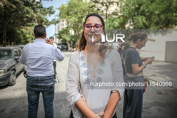 Chaima Issa, human rights activist and a senior member of the National Salvation Front, poses for photos as she attends a demonstration stag...