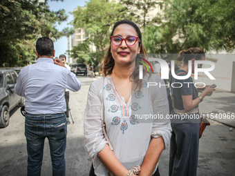 Chaima Issa, human rights activist and a senior member of the National Salvation Front, poses for photos as she attends a demonstration stag...