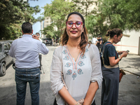 Chaima Issa, human rights activist and a senior member of the National Salvation Front, poses for photos as she attends a demonstration stag...