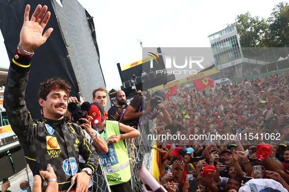 Charles Leclerc of Ferrari celebrates with fans after the Formula 1 Italian Grand Prix at Autodromo Nazionale di Monza in Monza, Italy on Se...