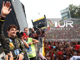 Charles Leclerc of Ferrari celebrates with fans after the Formula 1 Italian Grand Prix at Autodromo Nazionale di Monza in Monza, Italy on Se...