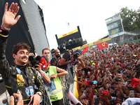 Charles Leclerc of Ferrari celebrates with fans after the Formula 1 Italian Grand Prix at Autodromo Nazionale di Monza in Monza, Italy on Se...