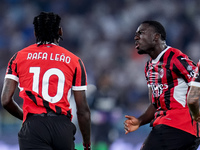 Rafael Leao of AC Milan celebrates with Youssouf Fofana after scoring second goal during the Serie A Enilive match between SS Lazio and AC M...