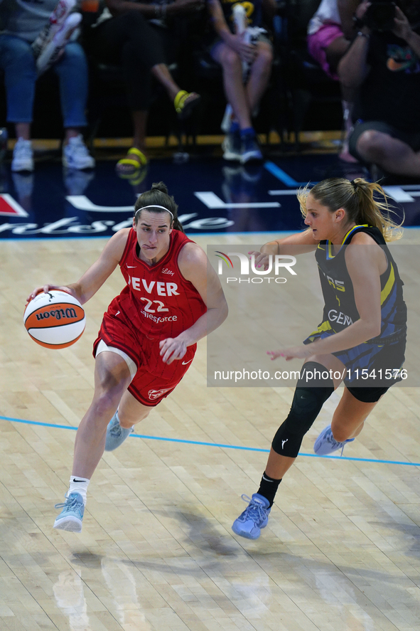 Indiana guard Caitlin Clark #22 drives to the basket against Dallas guard Jacy Sheldon #4 during the WNBA match at College Park Center. Indi...