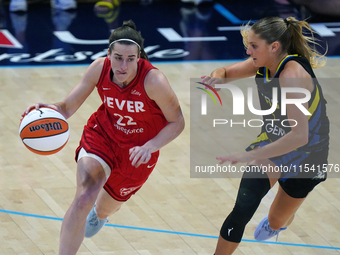 Indiana guard Caitlin Clark #22 drives to the basket against Dallas guard Jacy Sheldon #4 during the WNBA match at College Park Center. Indi...