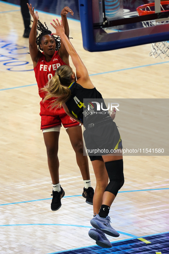 Indiana guard Kelsey Mitchell #0 shoots the ball over Dallas guard Jacy Sheldon #4 during the WNBA match against the Dallas Wings at College...