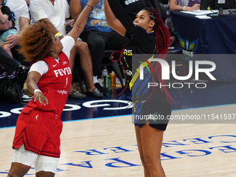 Dallas forward Satou Sabally #0 shoots the ball over Indiana forward NaLyssa Smith #1 during the WNBA match against Indiana Fever at College...