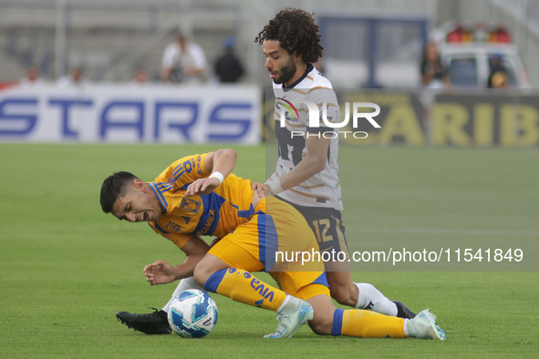 Cesar Huerta #12 of Pumas and Jesus Angulo #27 of Tigres battle for the ball during Matchday 6 as part of the Torneo de Apertura 2024 Liga M...