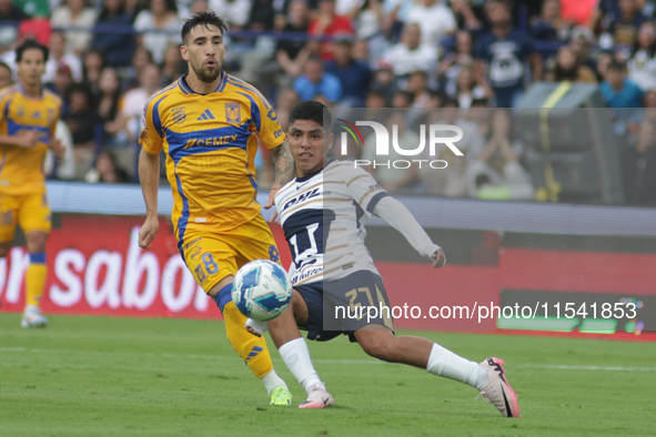 Piero Quispe #27 of Pumas slides to the ball against Fernando Gorriaran #8 of Tigres during Matchday 6 as part of the Torneo de Apertura 202...