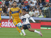 Piero Quispe #27 of Pumas slides to the ball against Fernando Gorriaran #8 of Tigres during Matchday 6 as part of the Torneo de Apertura 202...