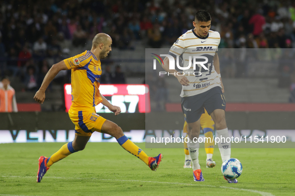 Guillermo Martinez Ayala #9 of Pumas drives the ball against Guido Pizarro #19 of Tigres during Matchday 6 as part of the Torneo de Apertura...