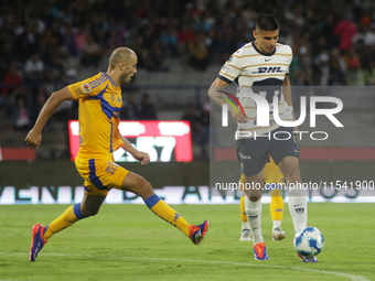 Guillermo Martinez Ayala #9 of Pumas drives the ball against Guido Pizarro #19 of Tigres during Matchday 6 as part of the Torneo de Apertura...