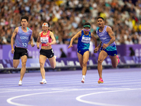 Jerusa Geber Dos Santos and her guide Gabriel Aparecido Santos Garcia of Team Brasil compete in the Women's 100m - T11 Semi-Finals at Stade...