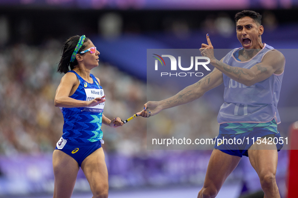 Jerusa Geber Dos Santos and her guide Gabriel Aparecido Santos Garcia of Team Brasil react after qualifying with the world record to Women's...