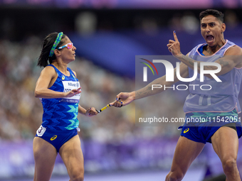 Jerusa Geber Dos Santos and her guide Gabriel Aparecido Santos Garcia of Team Brasil react after qualifying with the world record to Women's...