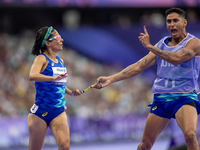 Jerusa Geber Dos Santos and her guide Gabriel Aparecido Santos Garcia of Team Brasil react after qualifying with the world record to Women's...