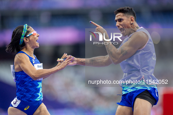 Jerusa Geber Dos Santos and her guide Gabriel Aparecido Santos Garcia of Team Brasil react after qualifying with the world record to Women's...