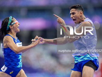 Jerusa Geber Dos Santos and her guide Gabriel Aparecido Santos Garcia of Team Brasil react after qualifying with the world record to Women's...