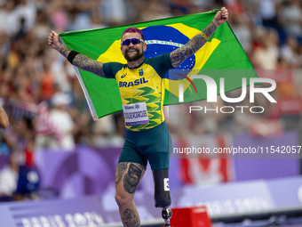 Vinicius Goncalves Rodrigues of Team Brazil reacts after winning the bronze medal in the Men's 100m - T63 Final at Stade de France during th...