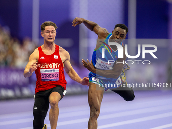 Maxcel Amo Manu of Italy (right) and Felix Streng of Germany (left) compete in the Men's 100m - T64 Final at Stade de France during the Pari...