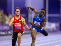 Maxcel Amo Manu of Italy (right) and Felix Streng of Germany (left) compete in the Men's 100m - T64 Final at Stade de France during the Pari...