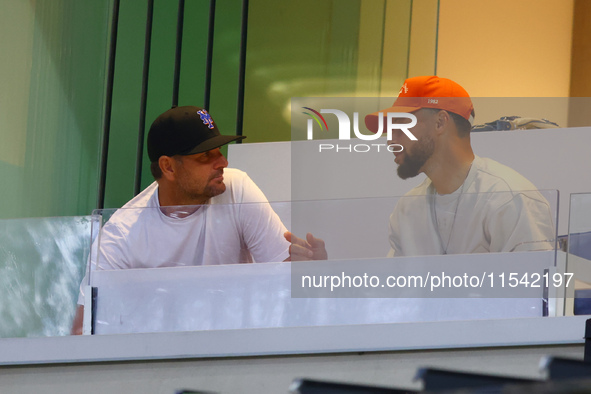 NBA star Stephen Curry sits in the owner's box during the baseball game against the Boston Red Sox at Citi Field in Corona, N.Y., on Septemb...