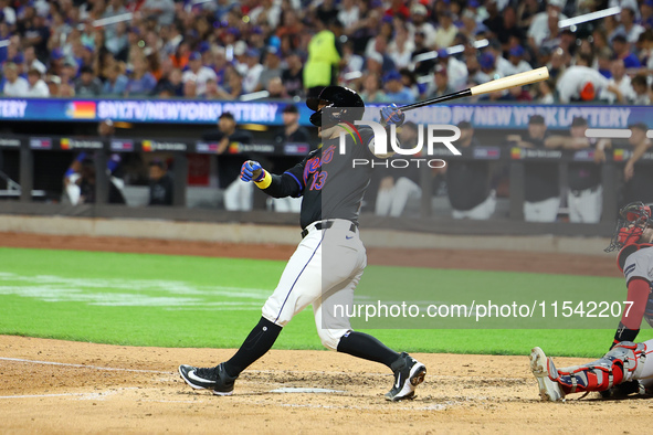 Luis Torrens #13 of the New York Mets doubles during the fourth inning of the baseball game against the Boston Red Sox at Citi Field in Coro...