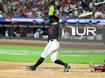 Luis Torrens #13 of the New York Mets doubles during the fourth inning of the baseball game against the Boston Red Sox at Citi Field in Coro...