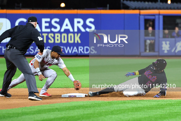 Luis Torrens #13 of the New York Mets doubles during the seventh inning of the baseball game against the Boston Red Sox at Citi Field in Cor...