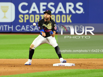 New York Mets second baseman Jeff McNeil takes the throw from third base and relays to first base for the double play during the fifth innin...