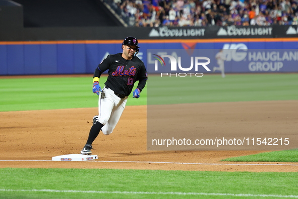 Luis Torrens #13 of the New York Mets scores from second base during the fourth inning of the baseball game against the Boston Red Sox at Ci...